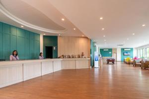 two women standing at a counter in a hospital lobby at Best Western Phuket Ocean Resort in Karon Beach +147 photos