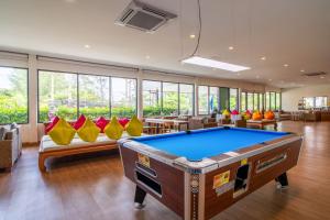 a pool table in a room with couches and chairs at Best Western Phuket Ocean Resort in Karon Beach