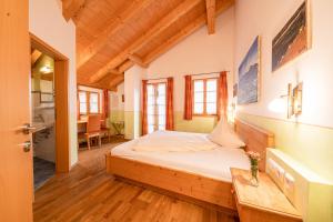 ein Schlafzimmer mit einem Bett in einem Zimmer mit Holzdecke in der Unterkunft Berggasthof Hotel Duftbräu I Ruhige Alleinlage I Mitten im Grünen in Samerberg