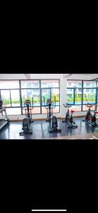 a gym with exercise bikes in a room with windows at Rieyo Homes Studio near Airport and SGR Train Station in Nairobi