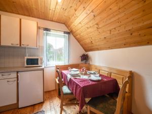 ein Esszimmer mit einem Tisch und einer Küche in der Unterkunft Berghütte in Sankt Andrä bei Koralpe in Reisberg