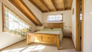 a bedroom with a bed and a window at Ocean's Edge at Bawley Beach in Bawley Point