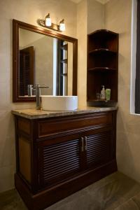a bathroom with a sink and a mirror at Yên Riverside Villa - Homestay Huế in Hue