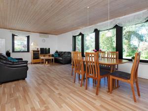 a living room with a dining room table and chairs at 6 person holiday home in Gedser-By Traum in Gedser +13 photos