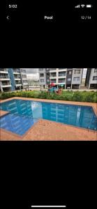 a picture of a swimming pool in front of a building at Rieyo Homes Studio near Airport and SGR Train Station in Nairobi