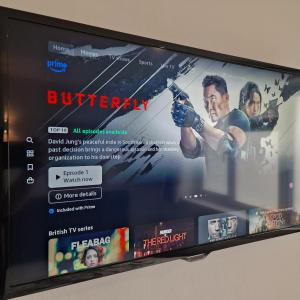 a television screen with a movie on it at Family-Friendly Bungalow near Salisbury in Alderbury