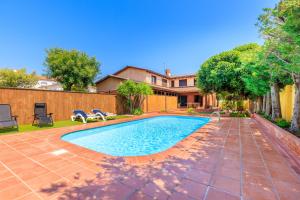 a swimming pool in the backyard of a house at Villa with private pool 3 minutes from the beach in Montroig