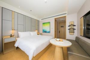 Ένα ή περισσότερα κρεβάτια σε δωμάτιο στο Ji Hotel Beijing Liujiayao