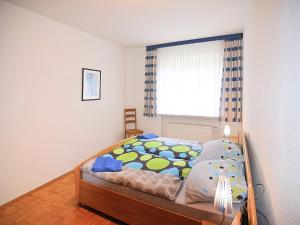 a bedroom with a bed and a window at Holiday farm situated next to the Kellerwald-Edersee national park with a sunbathing lawn in Bad Wildungen