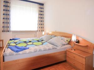 a bedroom with a wooden bed with a window at Holiday farm situated next to the Kellerwald-Edersee national park with a sunbathing lawn in Bad Wildungen +180 photos