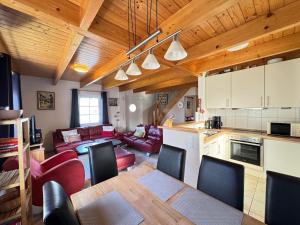a kitchen and living room with a table and chairs at Landgang 27 in Hemmoor