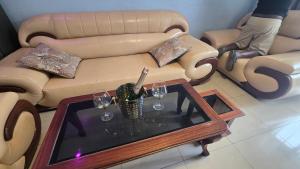 a living room with a couch and a table with wine glasses at Gravity Suites in Taba