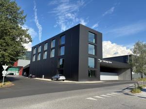 a black building with a car parked in front of it at Herburger Living in Dornbirn