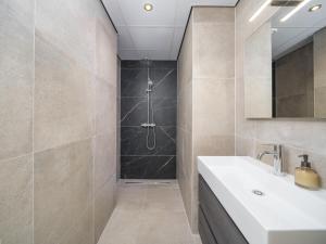 a bathroom with a sink and a shower at Groepsaccommodatie met hottub en sauna | 18 personen in Neede +62 photos