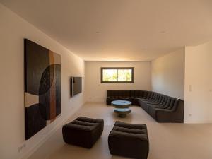 a living room with a couch and a table at Villa Adeona in Zonza
