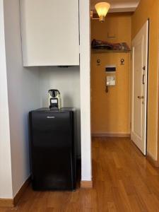 a black suitcase in a room with a hallway at Borgo Cavour Santi40 in Treviso
