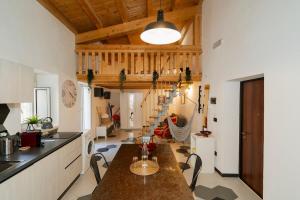 a kitchen with a wooden ceiling and a table at Naiadi Giudecca in Siracusa