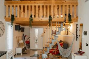 a loft with a hammock in a living room at Naiadi Giudecca in Siracusa