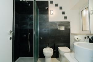 a bathroom with a shower and a toilet and a sink at Naiadi Giudecca in Siracusa +22 photos