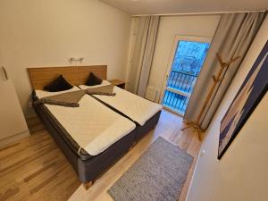 a bedroom with a bed and a large window at Home Inn GLPN36 in Stockholm