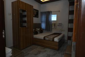 a small bedroom with a bed and a window at JS Inn in Varanasi