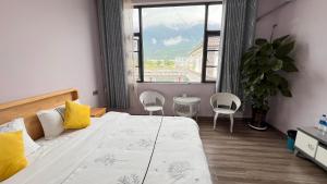 Postel nebo postele na pokoji v ubytování Dali Sifan Homestay