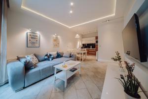 a living room with a blue couch and a table at Apartamenty Home Sweet Home in Szklarska Poręba +31 photos