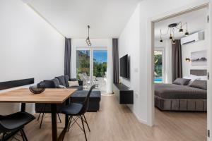 a living room with a bed and a dining room at Apartment in Villa Marealto with pool, garage and seaview in Ičići