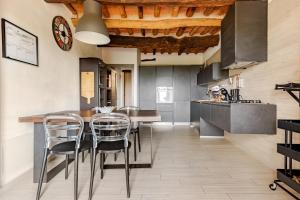 a kitchen with a table and chairs in a room at Margherita's Home in Chianti in San Donato in Poggio
