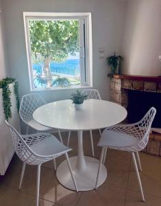 a white table and chairs in a room with a window at Sesi Luxury Suites Seaside & Private Pool in Marathon