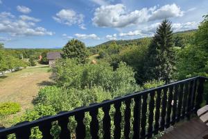 a balcony with a view of a field and trees at Cherry Hill Loft in Plitvička Jezera