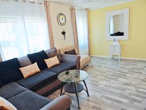 a living room with a couch and a table at Holiday home with private Garden and mountain view in Briton Ferry