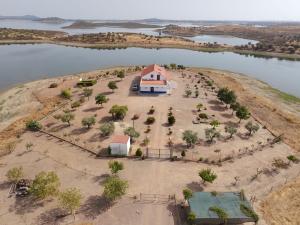 an aerial view of a house on an island in the water at Monte Dos Avós in Mourão