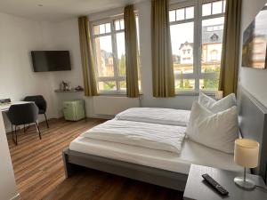 En eller flere senge i et værelse på Urlaubshaus-Erzgebirge