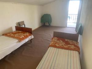 a small room with two beds and a window at Край отдыха дзорахбюур in Yerevan +63 photos