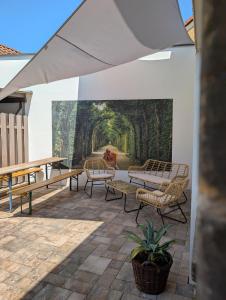 a patio with benches and a mural of a forest at Wallfried #2 Ferien- und Business Appartement Bayreuth in Bayreuth