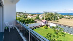 a balcony with a view of the ocean at SunriseDreamHouse in Ponta Delgada