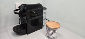 a black espresso machine sitting on top of a counter at TheLittlePrince 30m2 Studio OLD TOWN in Warsaw