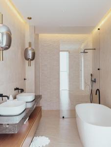 a white bathroom with two sinks and a tub at villaSAMU in Amphoe Koh Samui