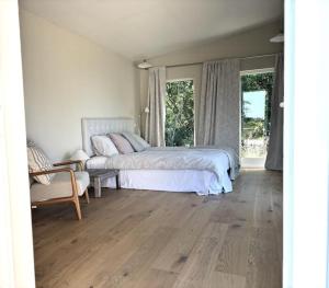 Un dormitorio con una cama y una silla y ventanas. en Boutique Home With Sea View In Vang, en Hasle 32 fotos más