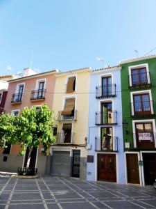 a row of colorful buildings in a street at Casa Hermes in Villajoyosa