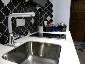 a kitchen sink with a faucet on a counter at Casa Hermes in Villajoyosa +32 photos