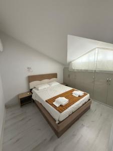 a bedroom with a large bed with two towels on it at Ares Vilları in Antalya +7 photos