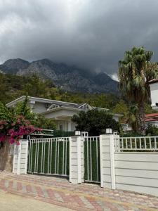a white fence in front of a house at Ares Vilları in Antalya