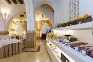 a buffet line in a large room with tables at Hotel Boutique Quinta Esencia in Toledo