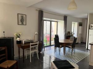 a kitchen and dining room with a table and chairs at La Ruelle in Die