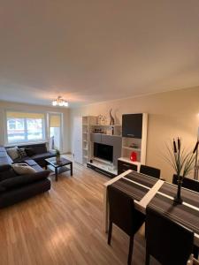 a living room with a couch and a table at 2BR Apartment - Free Parking, WiFi, Self Check-in in Klaipėda
