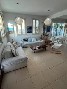 a living room with a couch and a table at Riverland Turtle Beach Villa-1min walk to beach in Protaras