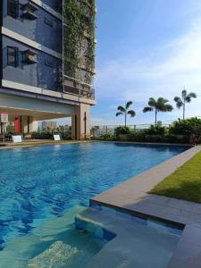 a large swimming pool in front of a building at Red Residences in Manila