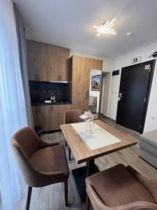 a living room with a dining room table and chairs at Soko IN Spa in Soko Banja